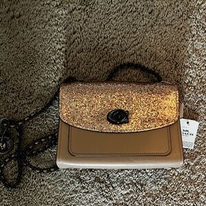 Authentic Coach pink with glitter purse. Still has original tags.
